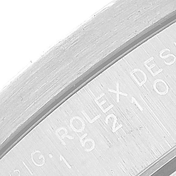 This image shows a close-up of the engraved text on the interior rim of a Rolex Date 15210 Men's Stainless Steel Blue Dial 15210 Men's Stainless Steel Blue Dial model watch.