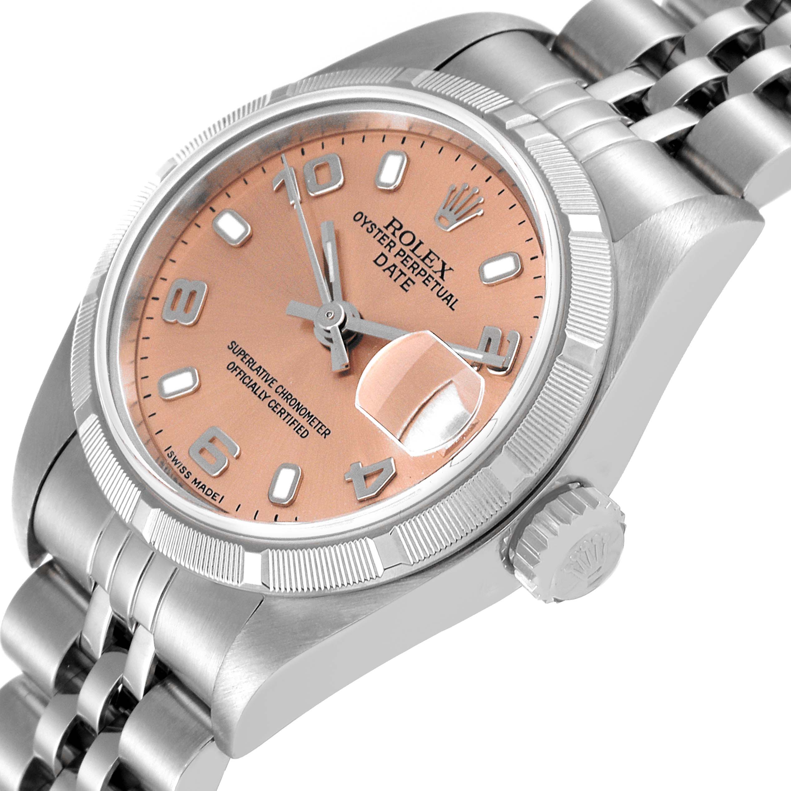 The Rolex Date 79190 Women's Stainless Steel Pink Dial 79190 Women's Stainless Steel Pink Dial model watch is shown from an angled view, highlighting the peach-colored dial, date magnifier, crown, and part of the bracelet.