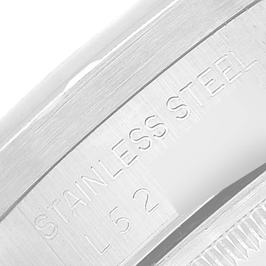 The image shows an engraved part of the Rolex Date 15210 Men's Stainless Steel Silver Dial 15210 Men's Stainless Steel Silver Dial model, highlighting "STAINLESS STEEL L 52."