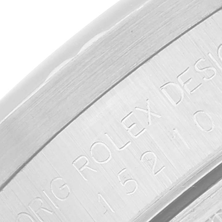 This close-up image shows the engraved serial number and text on the bezel or casing of a Rolex Date 15210 Men's Stainless Steel Silver Dial 15210 Men's Stainless Steel Silver Dial model watch.