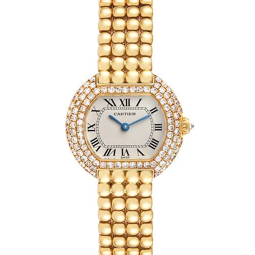 The image shows a front view of a Cartier Tortue Women's Yellow Gold Silver Dial Women's Yellow Gold Silver Dial watch featuring a gold band and a diamond-encrusted case.