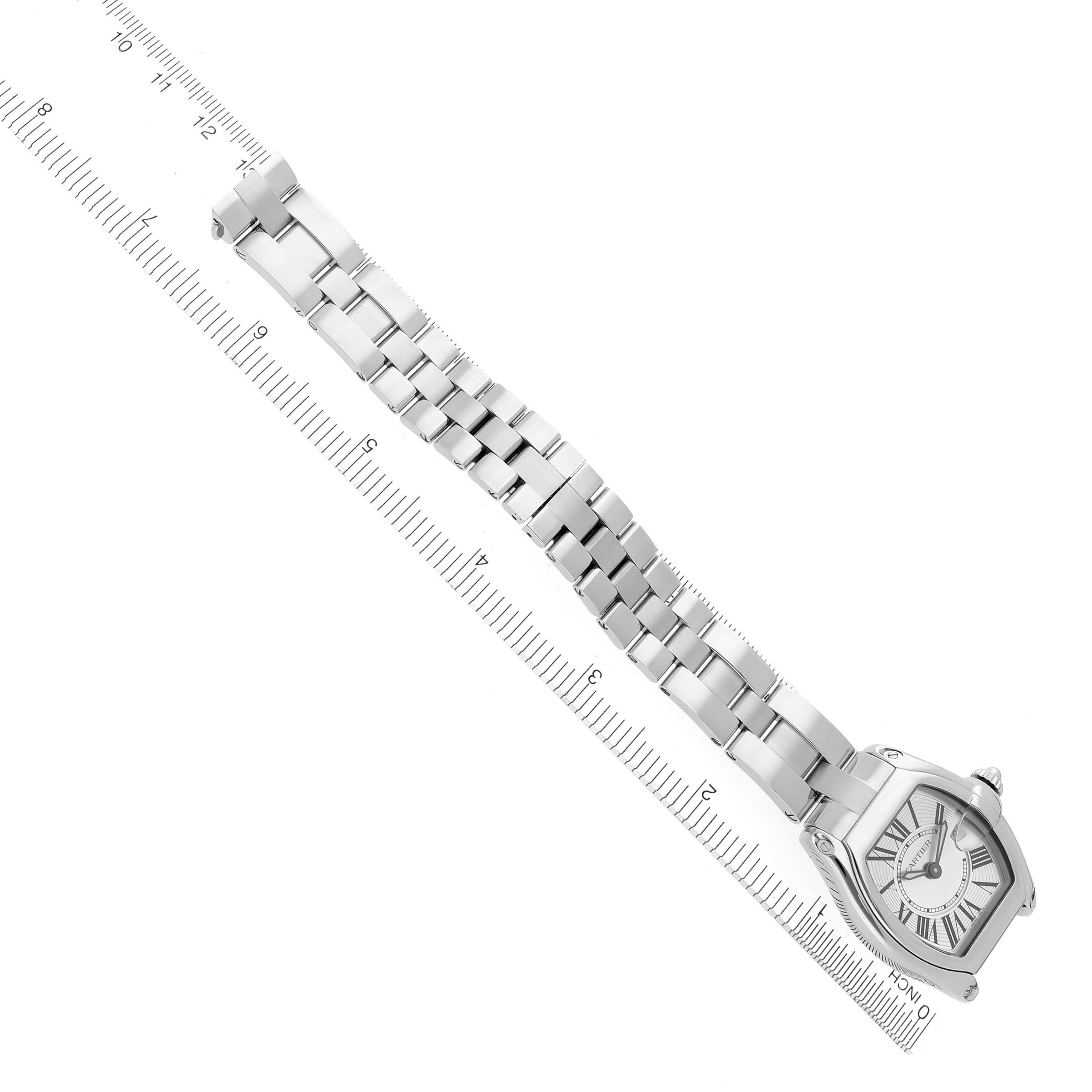 The Cartier Roadster W62016V3 Women's Stainless Steel Silver Dial W62016V3 Women's Stainless Steel Silver Dial watch is shown at an angled top view, displaying the watch face and full bracelet against a ruler background.