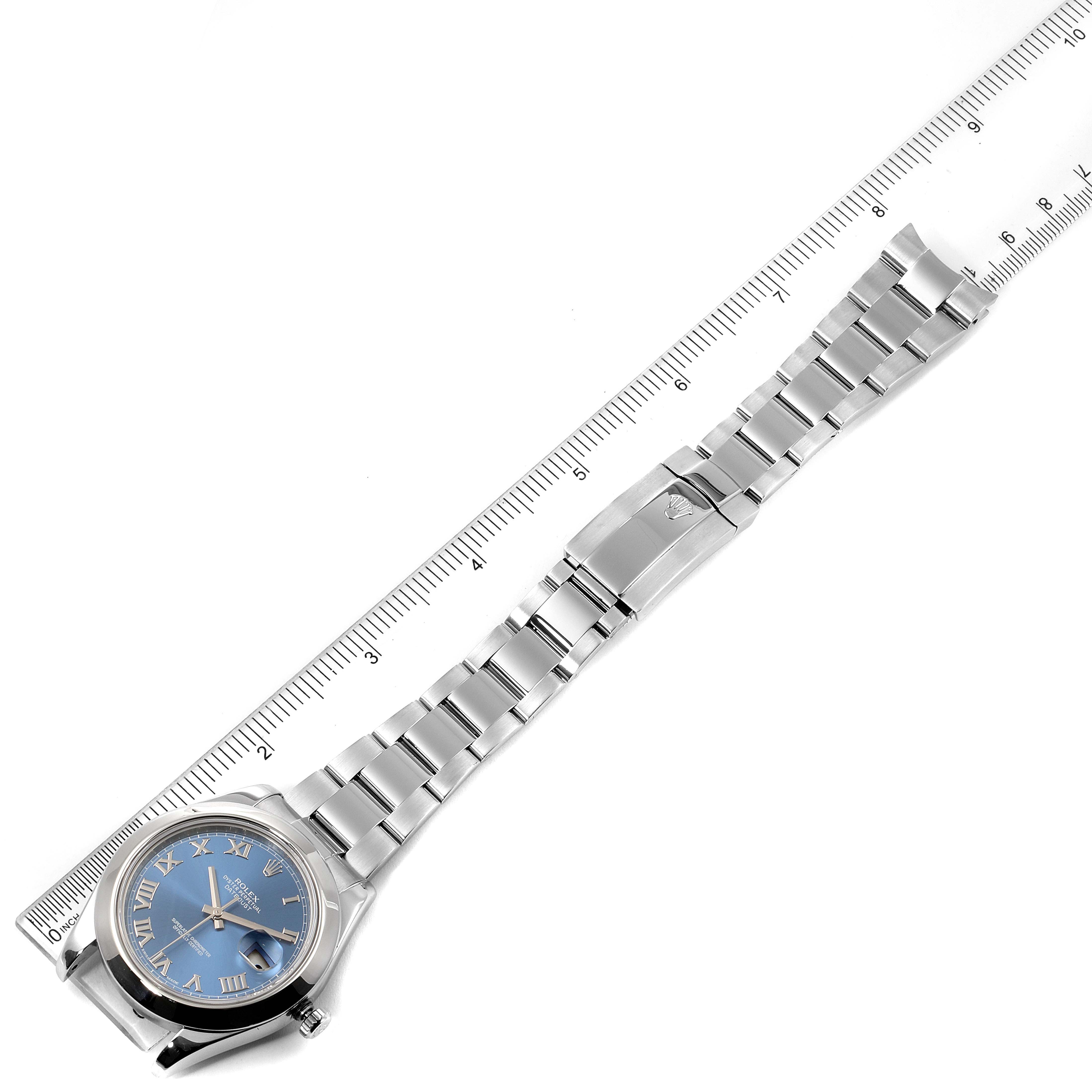 This image shows a Rolex Datejust 41 116300 Men's Stainless Steel Blue Dial 116300 Men's Stainless Steel Blue Dial watch laid flat with its blue dial and stainless steel bracelet next to a ruler.