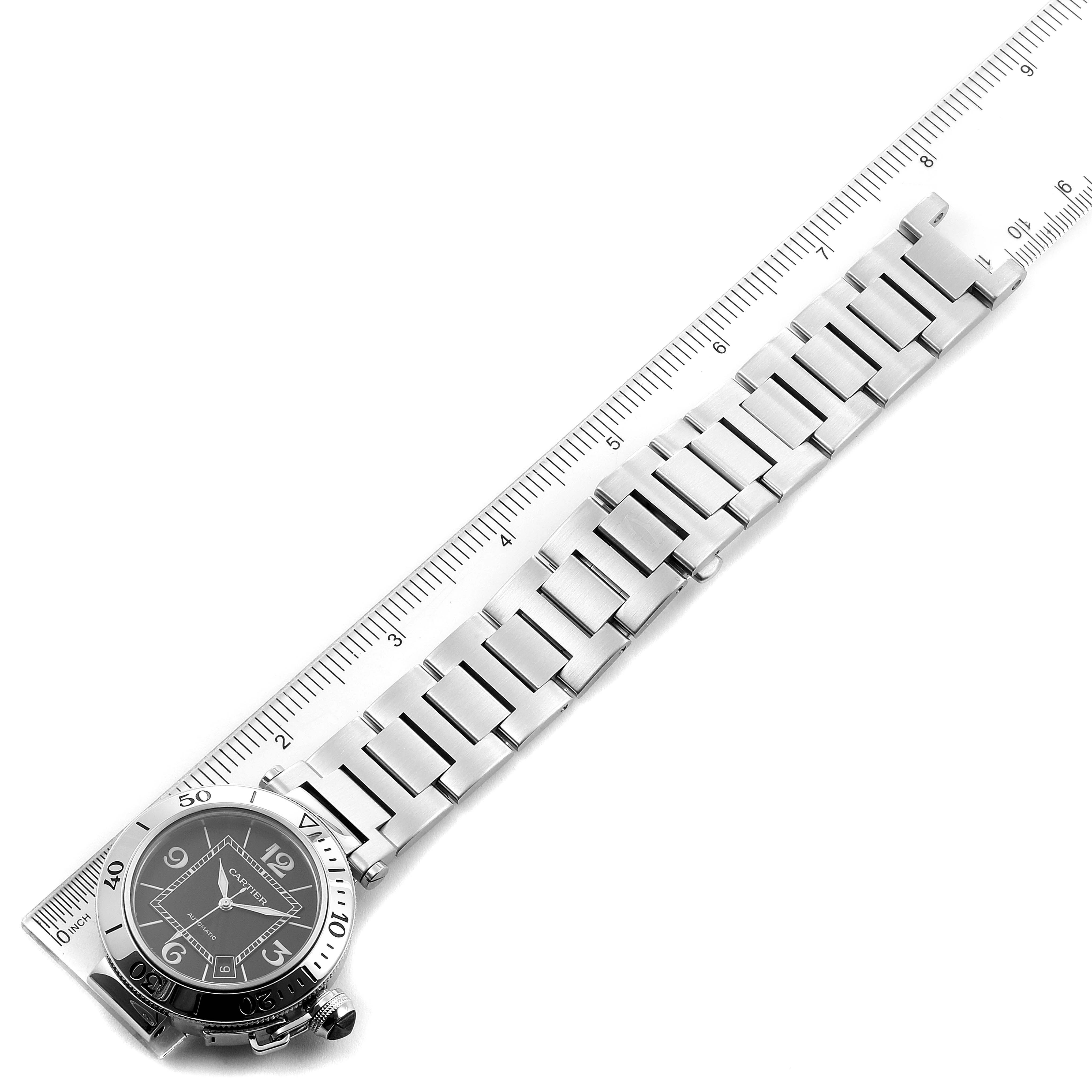This image shows the face and full bracelet of the Cartier Pasha W31077M7 Men's Stainless Steel Black Dial W31077M7 Men's Stainless Steel Black Dial watch, laid flat next to a ruler for measurement.