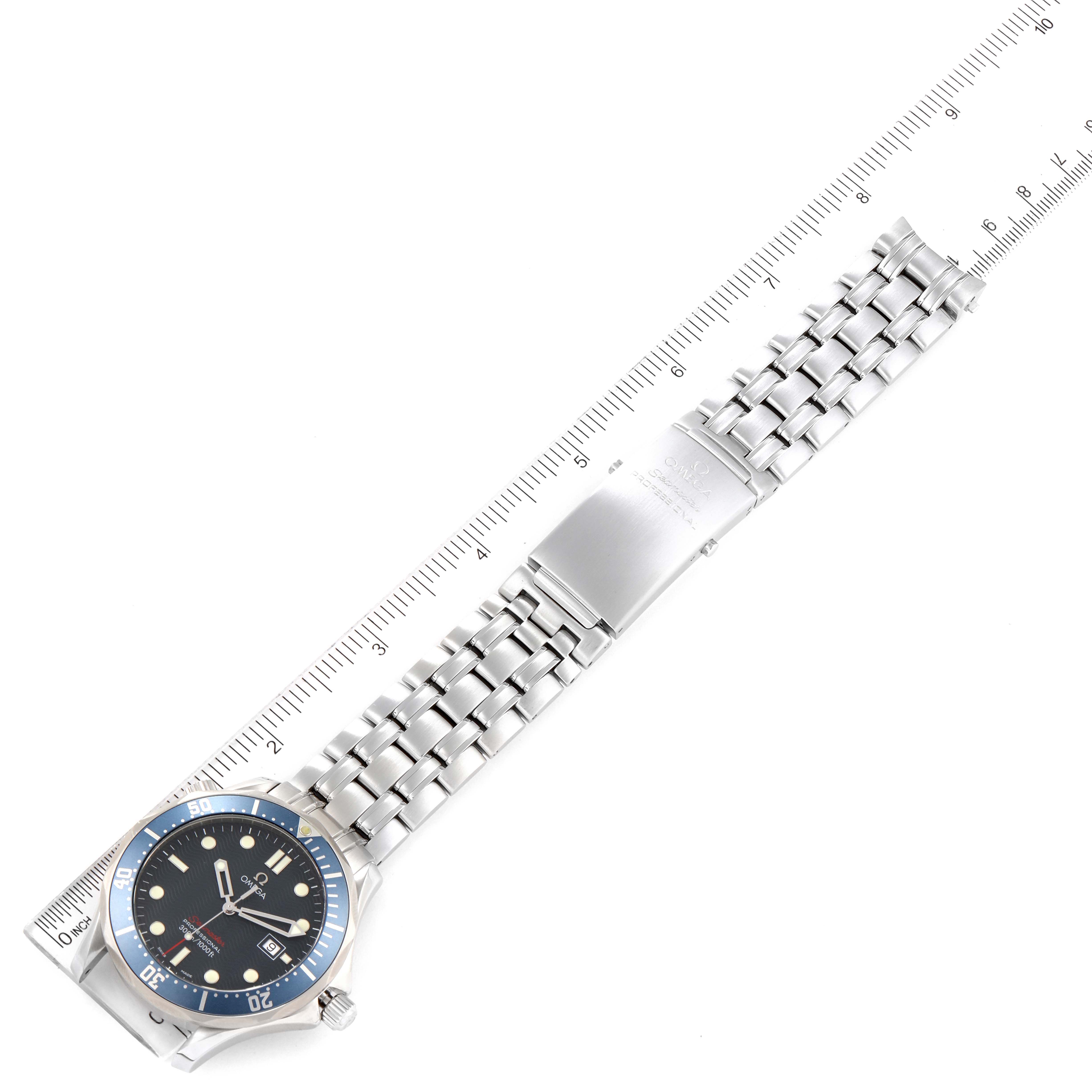 The Omega Seamaster 2221.80.00 Men's Stainless Steel Blue Dial 2221.80.00 Men's Stainless Steel Blue Dial watch is shown laid flat with a ruler, highlighting the bracelet and clasp.