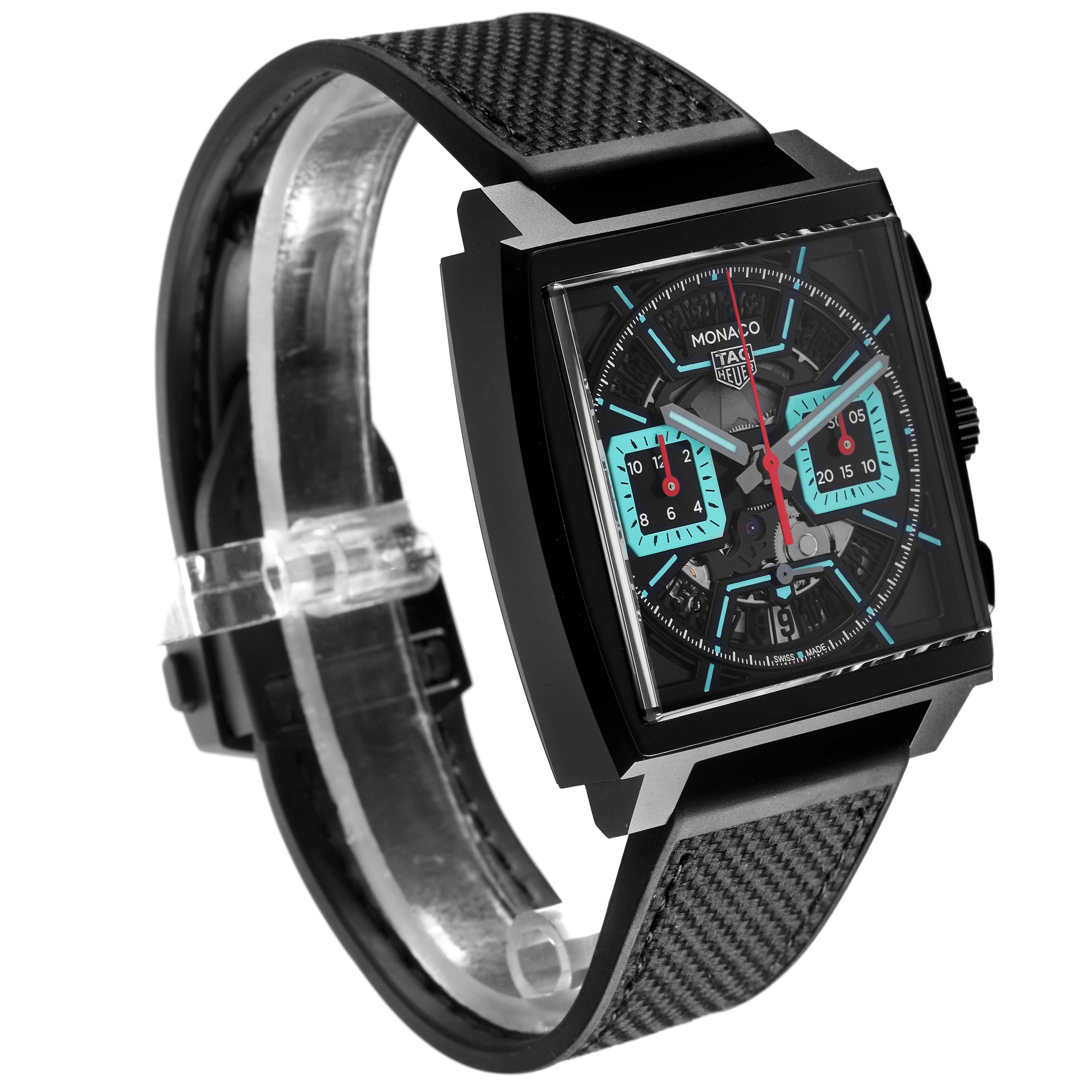 The Tag Heuer Monaco CBL2184.FT6236 Men's Titanium Transparent Dial CBL2184.FT6236 Men's Titanium Transparent Dial watch is shown at a slight angle, highlighting its square face, chronograph dials, and textured strap.