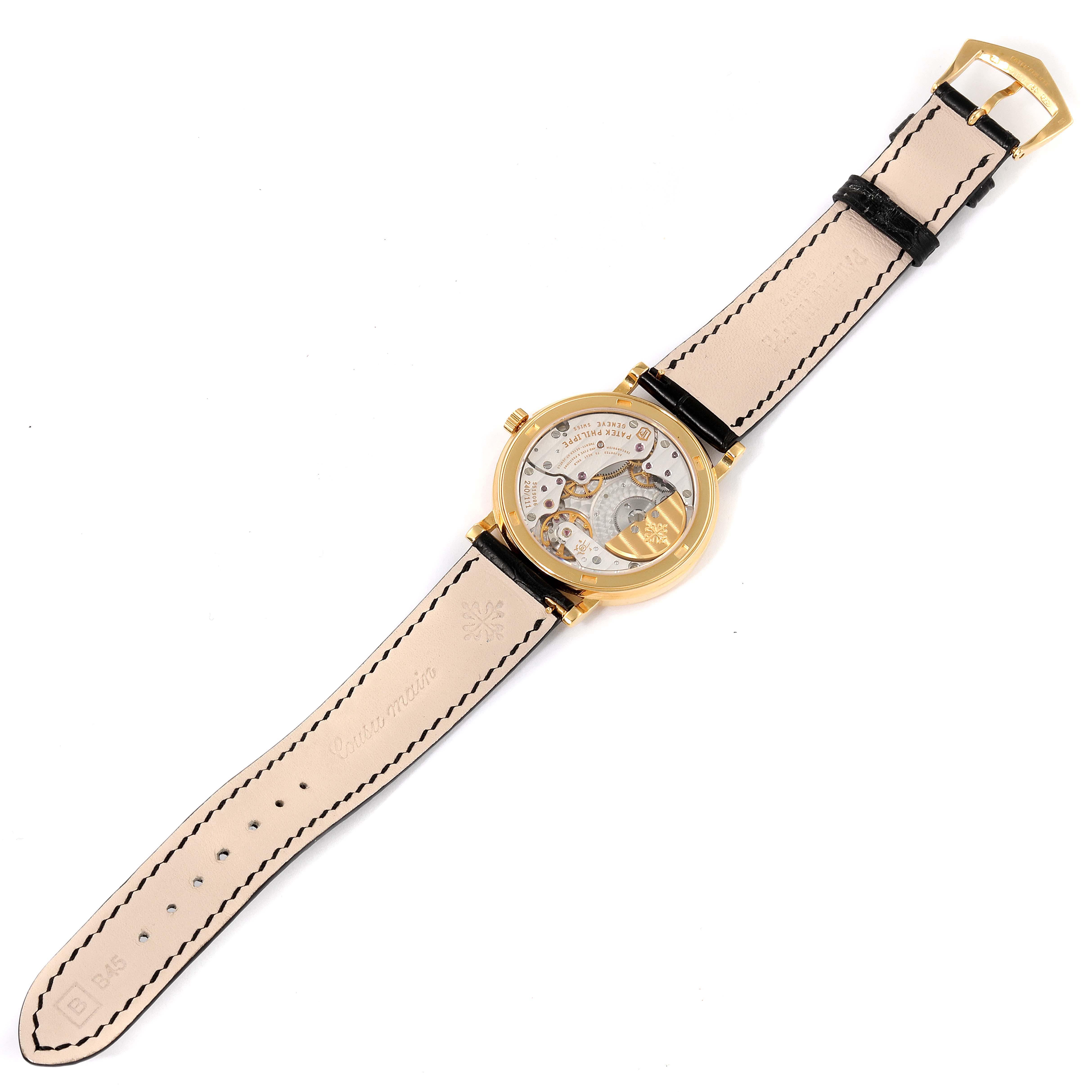 The image shows the back view of a Patek Philippe Calatrava 5120J Men's Yellow Gold White Dial 5120J Men's Yellow Gold White Dial watch, displaying the movement and leather strap.