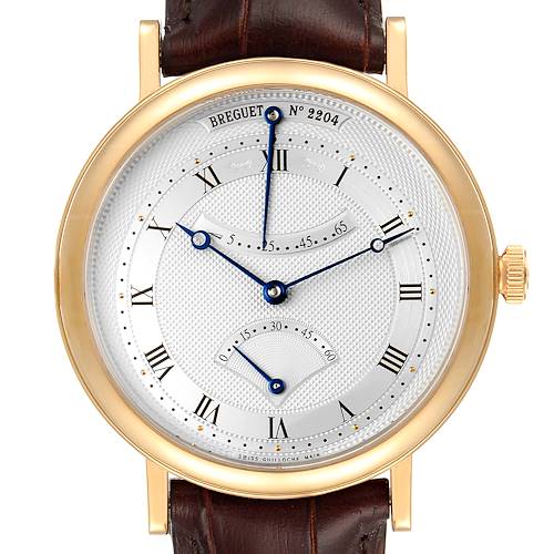This image showcases the face of a Breguet Classique 5207BA/12/9V6 Men's Yellow Gold Silver Dial 5207BA/12/9V6 Men's Yellow Gold Silver Dial model watch, displaying Roman numerals, blue hands, and a gold case.