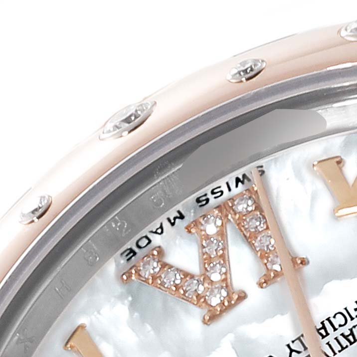 This image shows the upper part of the watch face and bezel of a mid-size Rolex model with a diamond-accented Roman numeral and a "Swiss Made" marking.