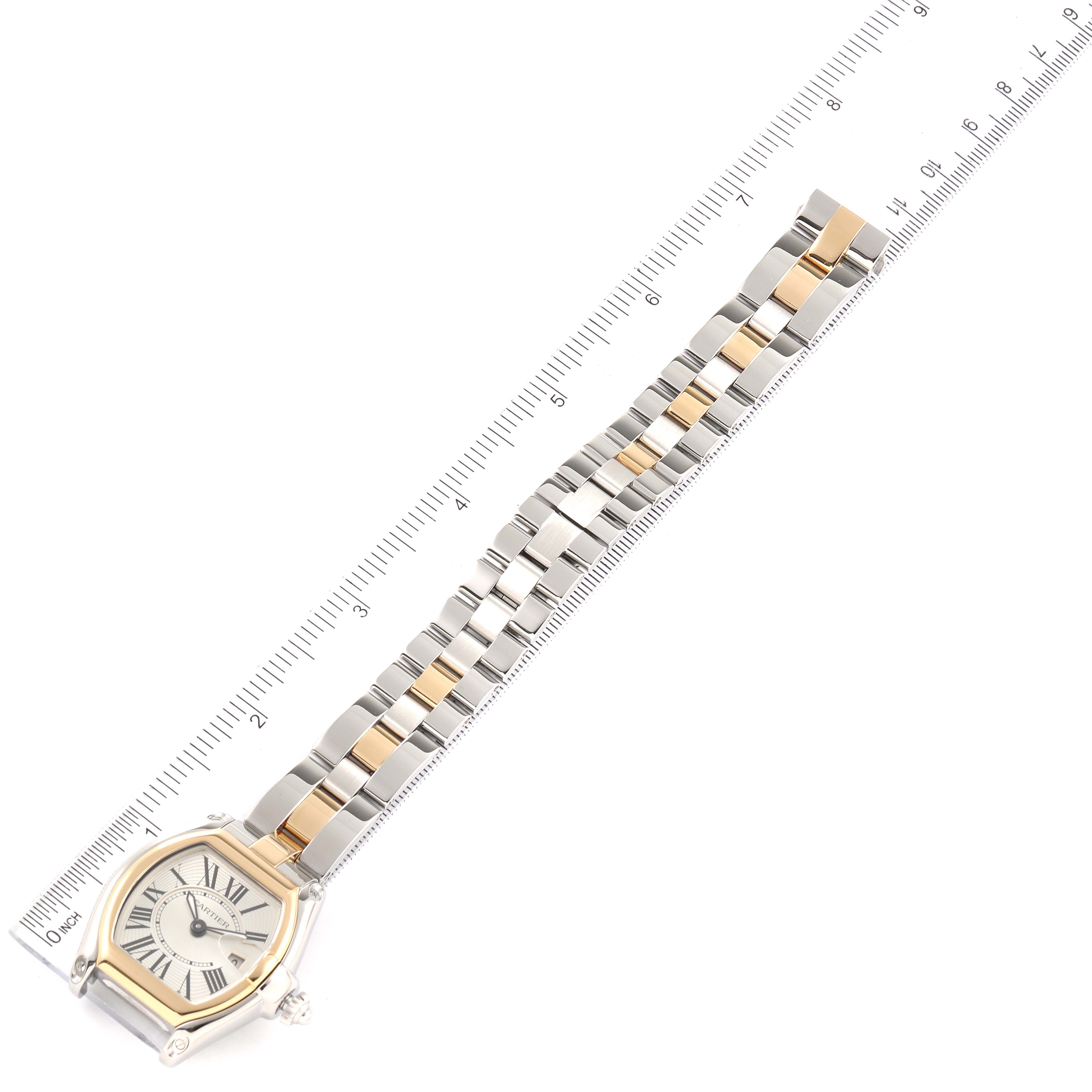 The image shows a top-down view of a Cartier Roadster W62026Y4 Women's Steel and Gold (two tone) Silver Dial W62026Y4 Women's Steel and Gold (two tone) Silver Dial watch, including the face and the full length of the metal bracelet with a ruler alongside.