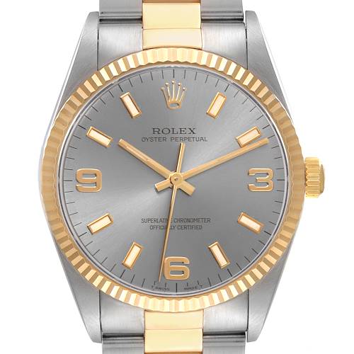 The image shows a frontal view of a Rolex Oyster Perpetual 14233 Men's Steel and Gold (two tone) Silver Dial 14233 Men's Steel and Gold (two tone) Silver Dial watch, highlighting the face, bezel, and part of the bracelet.