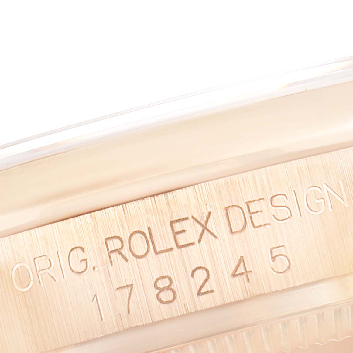 The image shows a close-up of the case side engraving on a Rolex President 178245 Women's Rose Gold White Dial 178245 Women's Rose Gold White Dial model, including the words "ORIG. ROLEX DESIGN" and the model number.