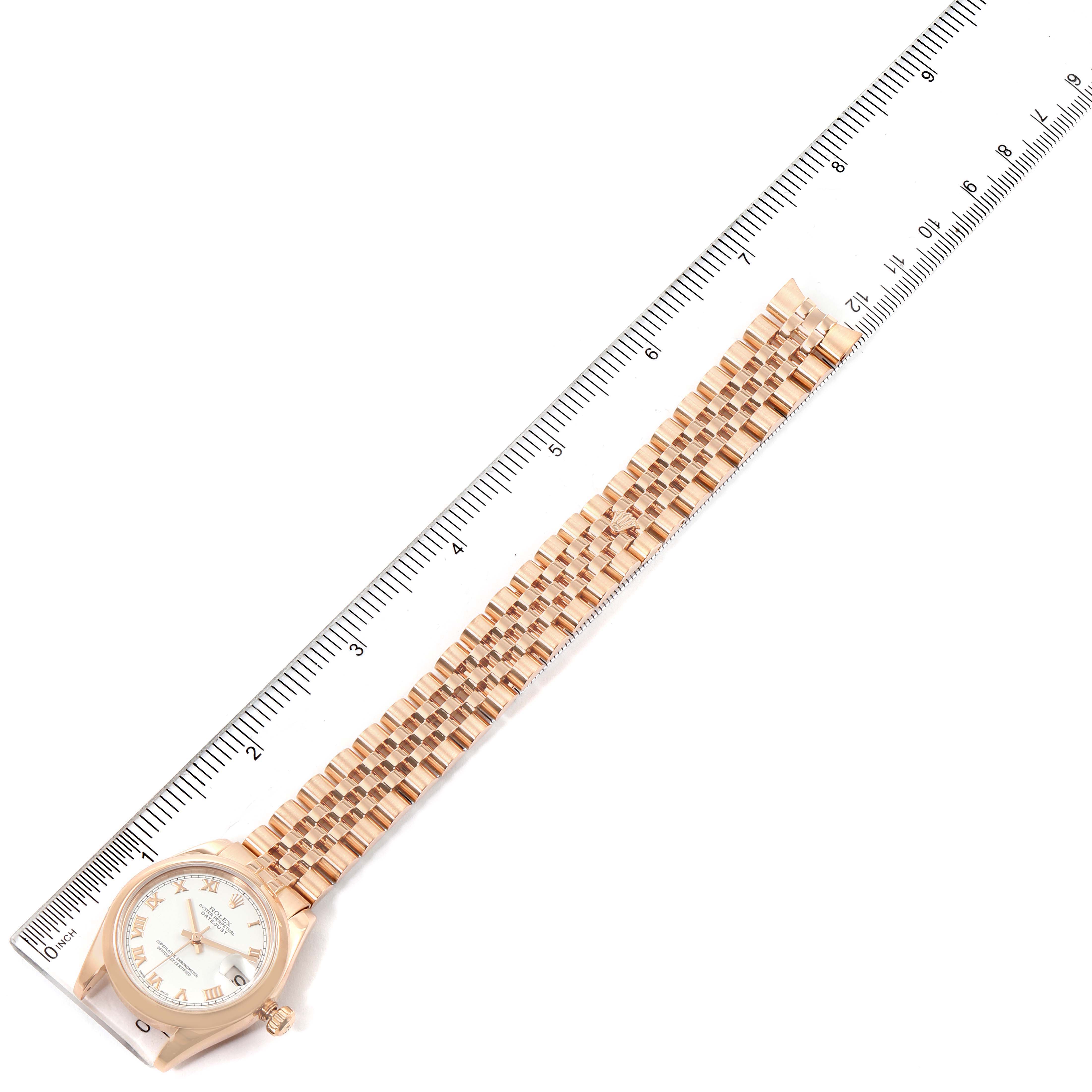 This image shows a Rolex President 178245 Women's Rose Gold White Dial 178245 Women's Rose Gold White Dial watch laid flat alongside a ruler, displaying the front face and full length of the bracelet.