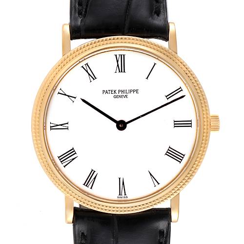 The image shows a front view of a Patek Philippe Calatrava 3954J Men's Yellow Gold White Dial 3954J Men's Yellow Gold White Dial watch with a gold case and black leather strap.