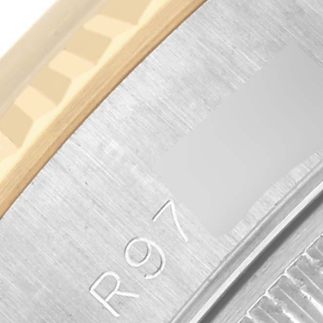 The image shows a close-up of the side of a Rolex Datejust 69173 Women's Steel and Gold (two tone) Champagne Dial 69173 Women's Steel and Gold (two tone) Champagne Dial watch, focusing on the fluted bezel and engraved details.