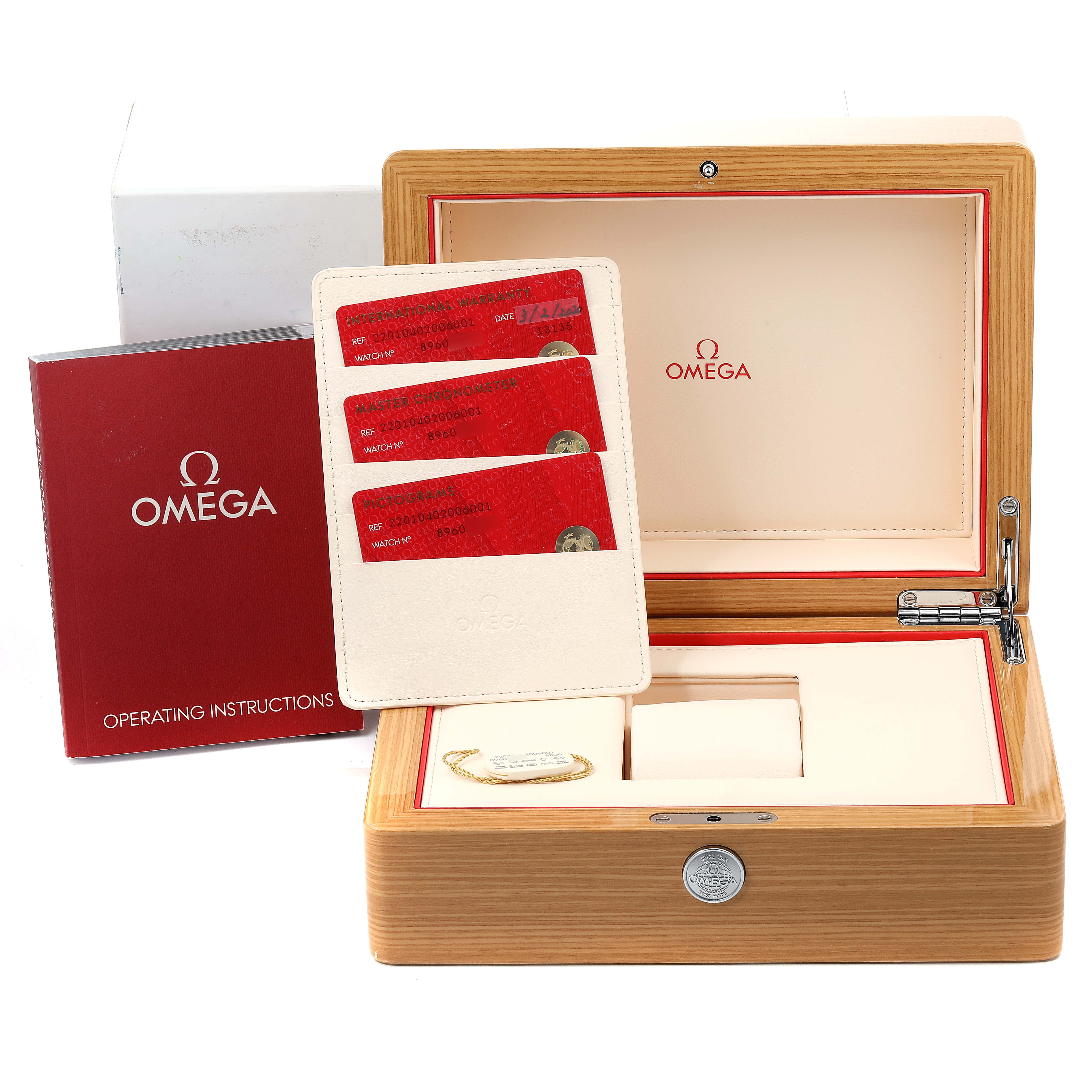 The image shows the Omega Seamaster 220.10.40.20.06.001 Men's Stainless Steel Grey Dial 220.10.40.20.06.001 Men's Stainless Steel Grey Dial watch packaging and accessories at an angle, including the box, instruction manual, and warranty cards.