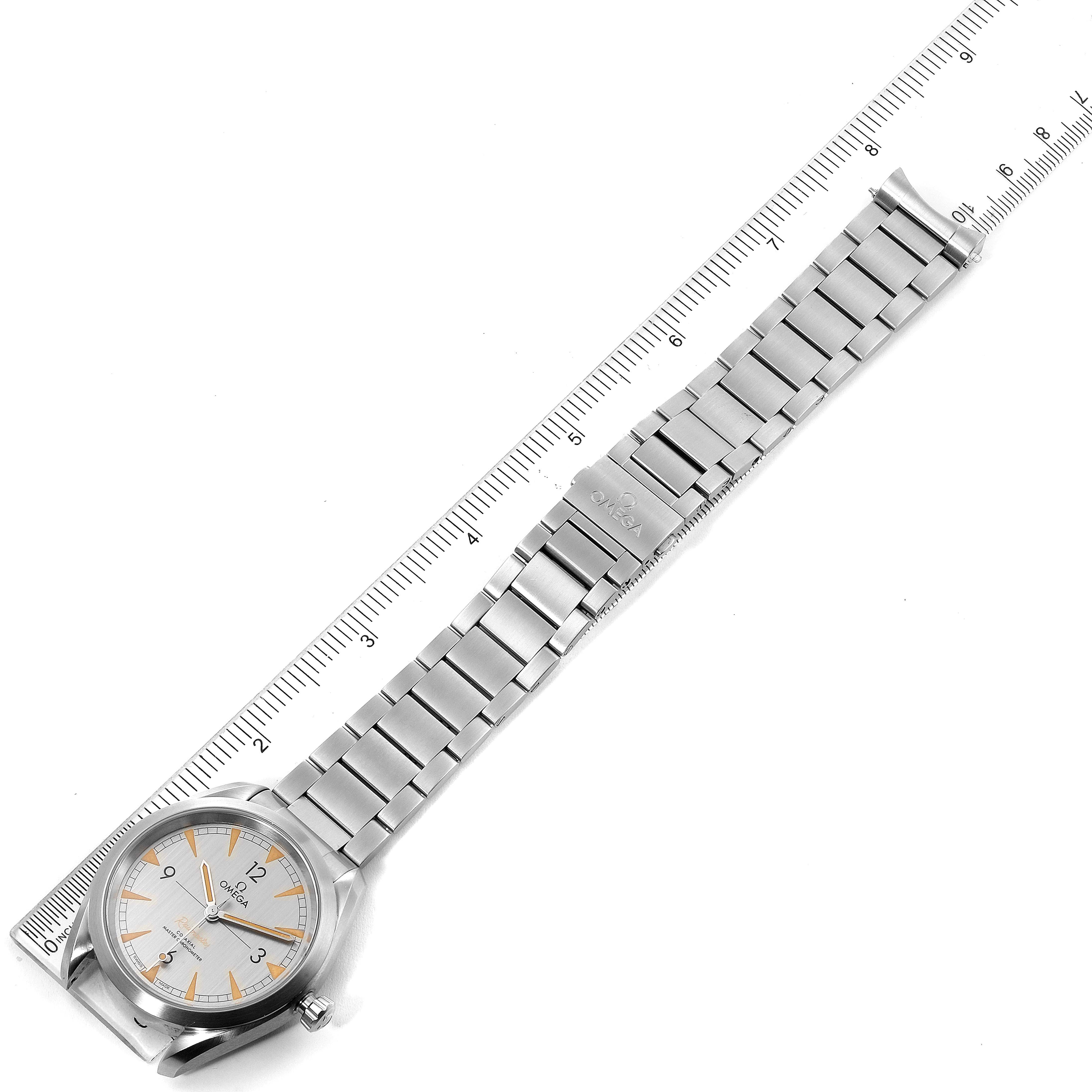 The image shows the front view of an Omega Seamaster 220.10.40.20.06.001 Men's Stainless Steel Grey Dial 220.10.40.20.06.001 Men's Stainless Steel Grey Dial watch, including the face, bracelet, and clasp alongside a ruler for scale.