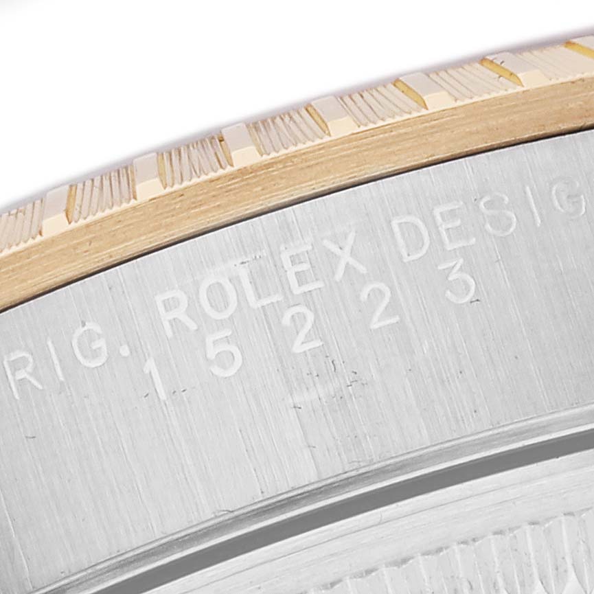 This close-up image shows the case and bezel engraving of a Rolex Date 15223 Men's Steel and Gold (two tone) White Dial 15223 Men's Steel and Gold (two tone) White Dial model watch.
