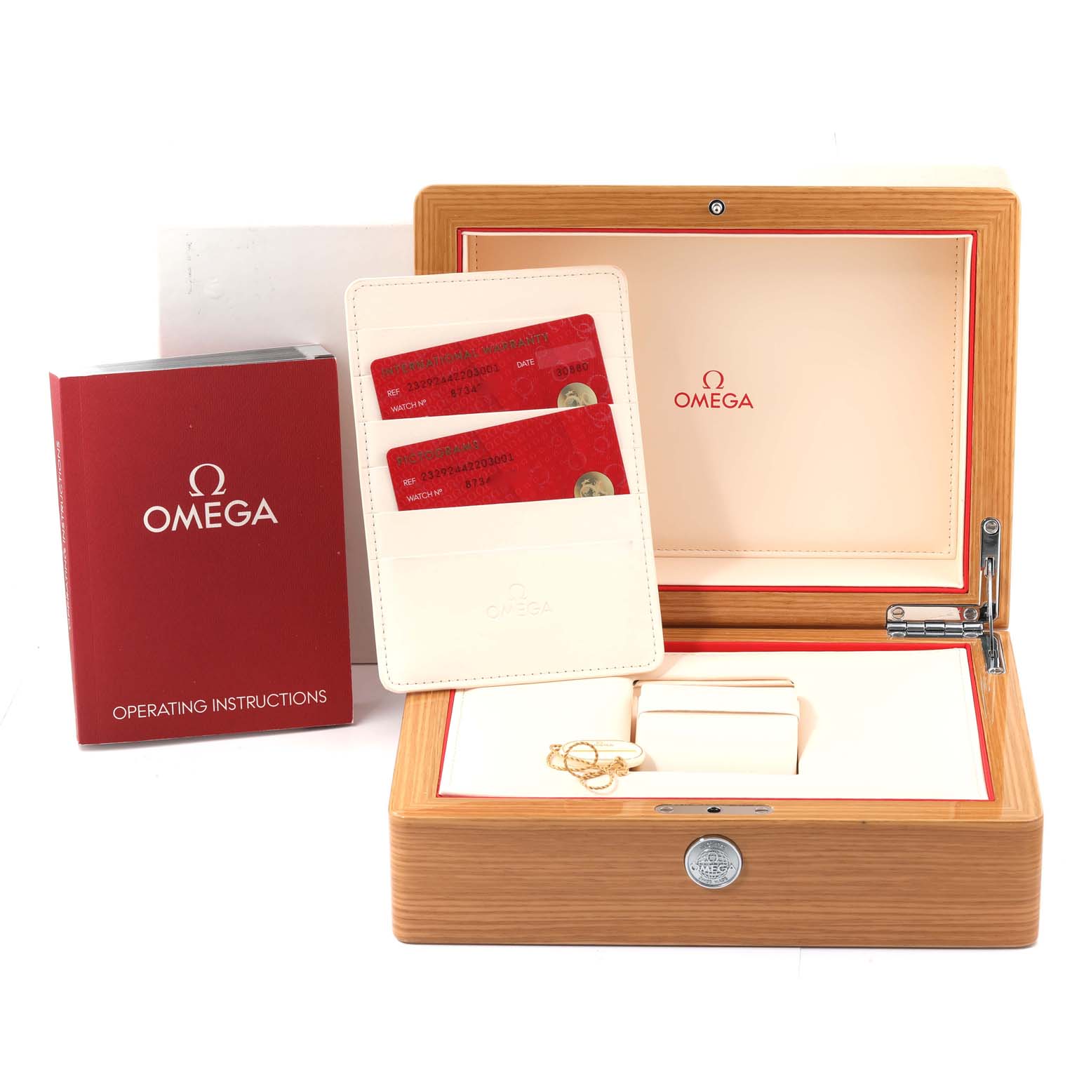 The image shows the box and accessories for the Omega Planet Ocean 232.92.44.22.03.001 Men's Titanium Blue Dial 232.92.44.22.03.001 Men's Titanium Blue Dial model, including operating instructions and warranty cards.