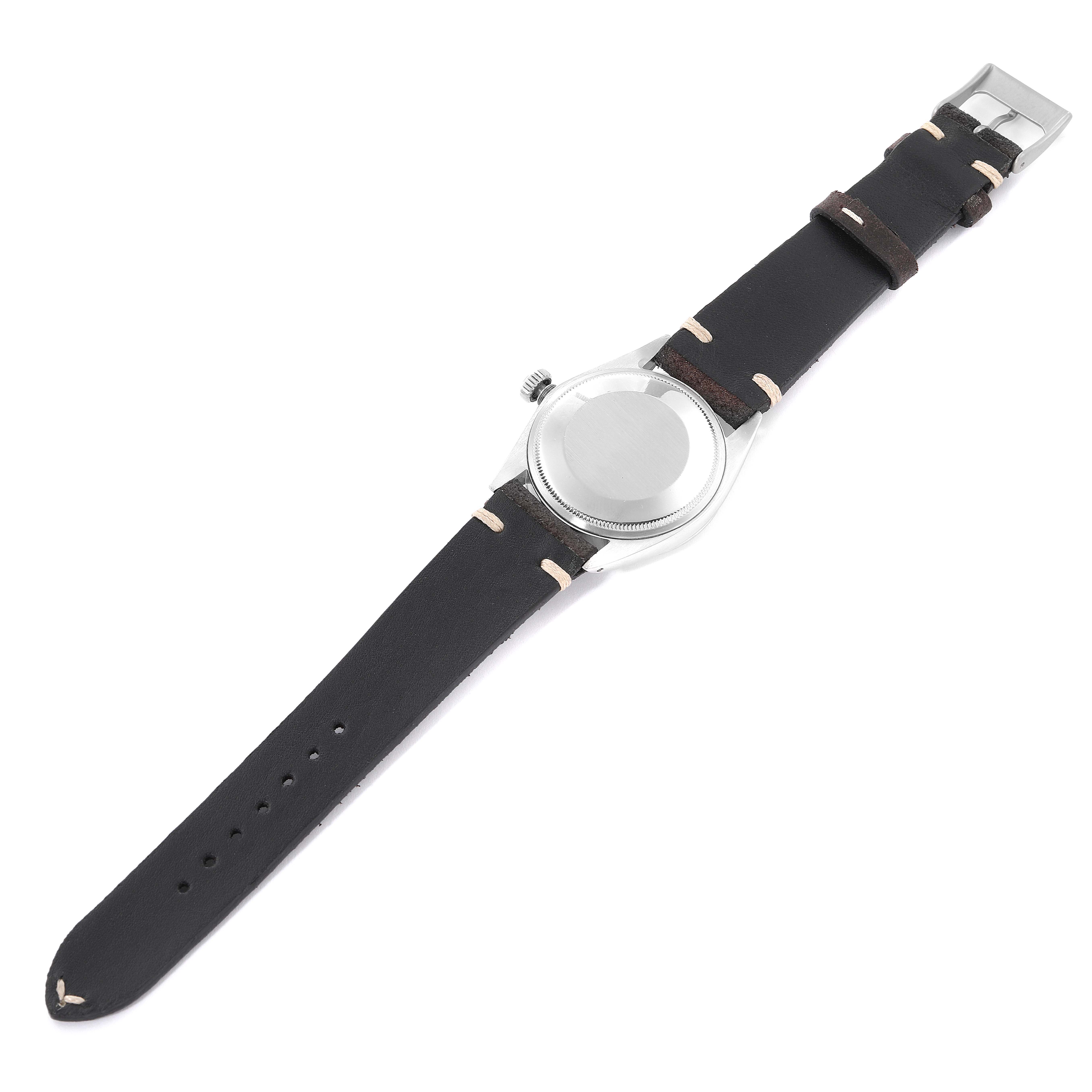 The image shows the back view of a Rolex Date 1500 Men's Stainless Steel Silver Dial 1500 Men's Stainless Steel Silver Dial model watch with a leather strap and stainless steel caseback.