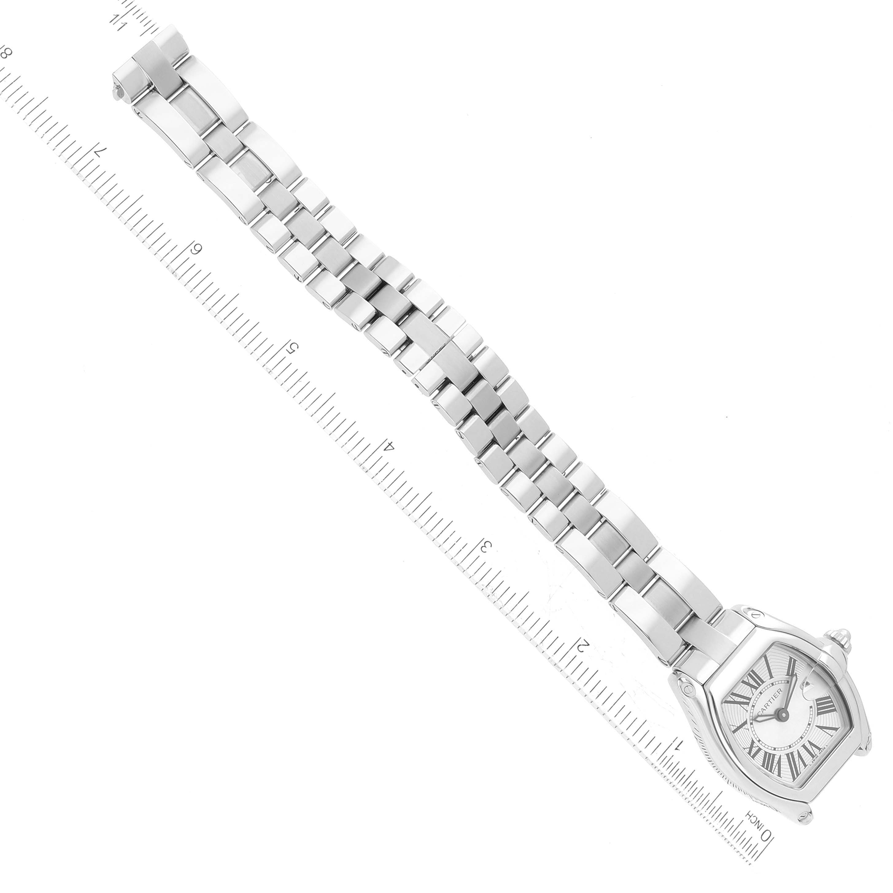 This image shows the full length and front view of the Cartier Roadster W62016V3 Women's Stainless Steel Silver Dial W62016V3 Women's Stainless Steel Silver Dial watch with a metal bracelet against a ruler for scale.