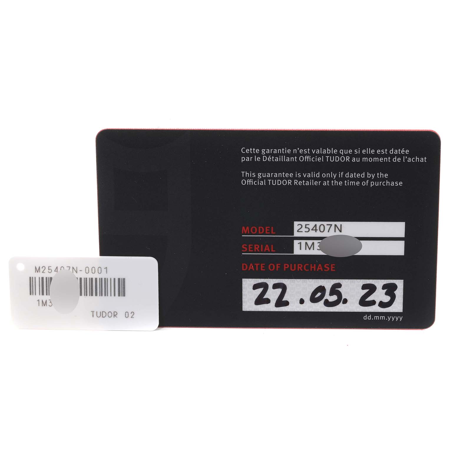 The image shows the warranty card for a Tudor Pelagos 25407N Men's Titanium Black Dial 25407N Men's Titanium Black Dial watch model and a serial number tag.