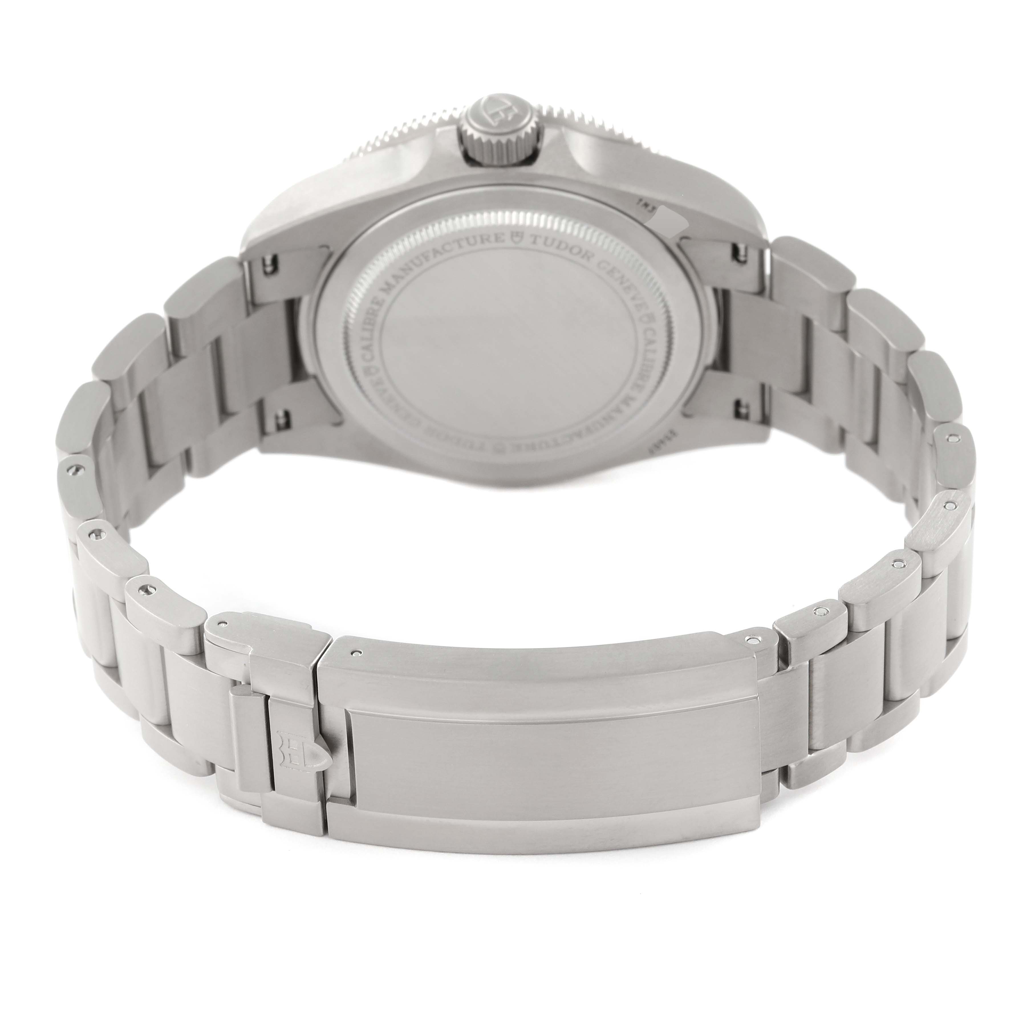 The image shows the backside and clasp of a Tudor Pelagos 25407N Men's Titanium Black Dial 25407N Men's Titanium Black Dial watch, including the case back and part of the metal bracelet.