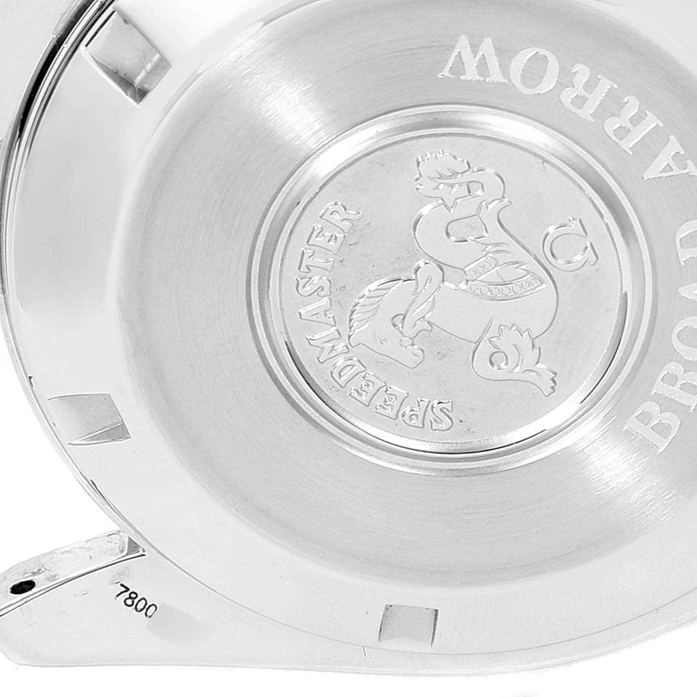 This image shows the case back of the Omega Speedmaster 3551.50.00 Men's Stainless Steel Black Dial 3551.50.00 Men's Stainless Steel Black Dial watch with an engraved logo and part of the bracelet.