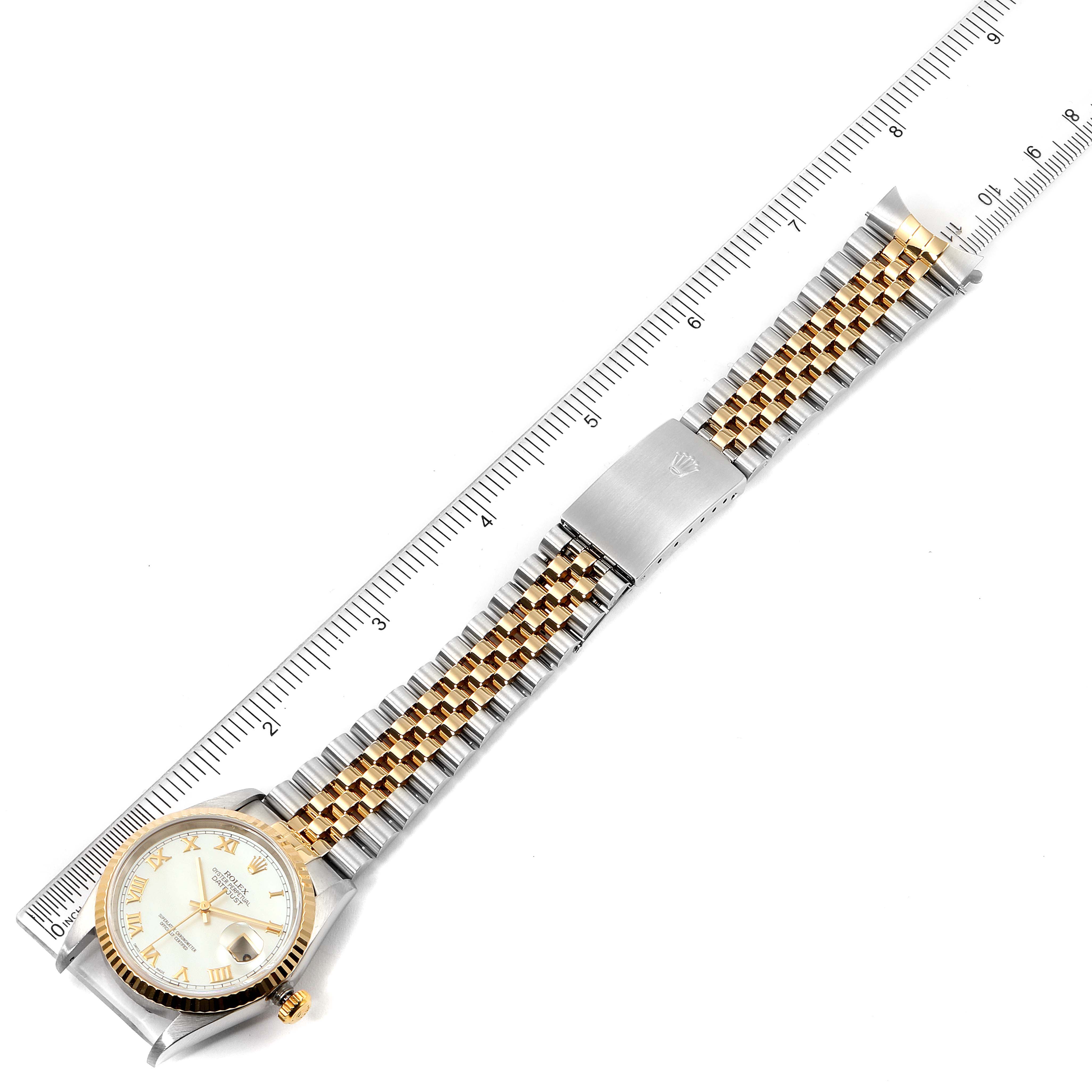 The image shows a Rolex Datejust 16233 Men's Steel and Gold (two tone) Mother of Pearl Dial 16233 Men's Steel and Gold (two tone) Mother of Pearl Dial watch laid flat with its face, bezel, and two-tone bracelet visible, alongside a ruler for scale.