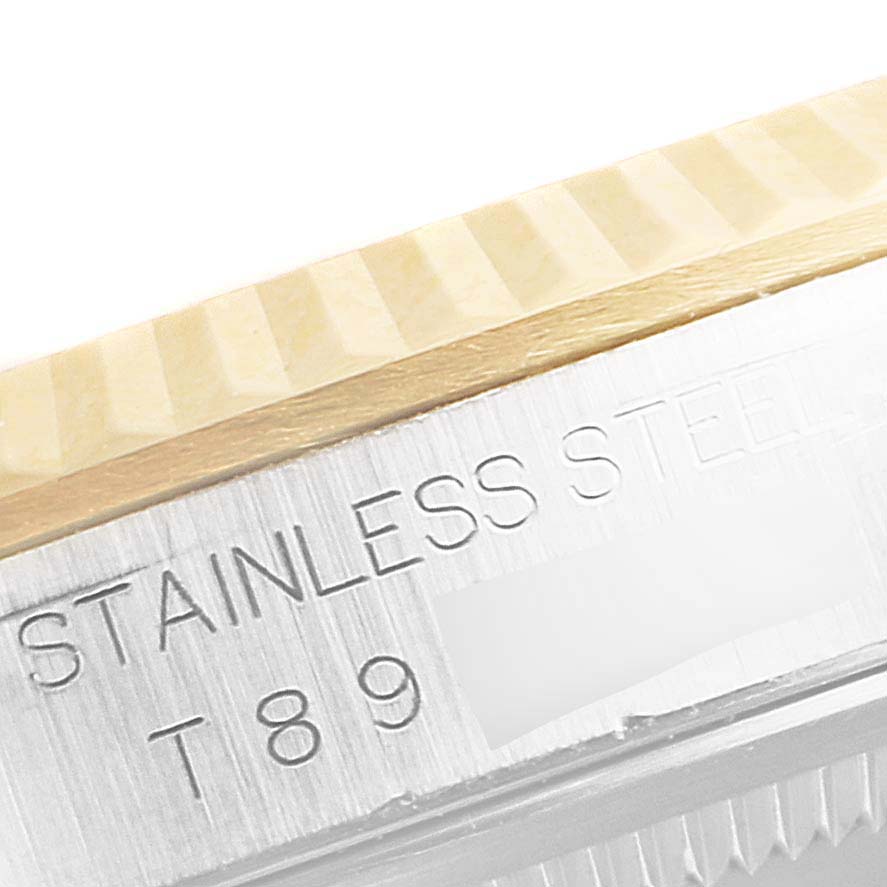 The image shows a close-up of the stainless steel and fluted bezel of a Rolex Datejust 16233 Men's Steel and Gold (two tone) Mother of Pearl Dial 16233 Men's Steel and Gold (two tone) Mother of Pearl Dial watch.