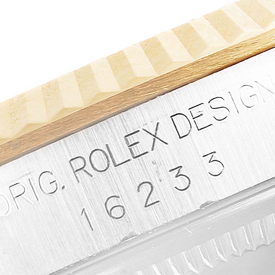 The image shows a close-up of the bezel and part of the caseback with engravings on a Rolex Datejust 16233 Men's Steel and Gold (two tone) Mother of Pearl Dial 16233 Men's Steel and Gold (two tone) Mother of Pearl Dial watch.