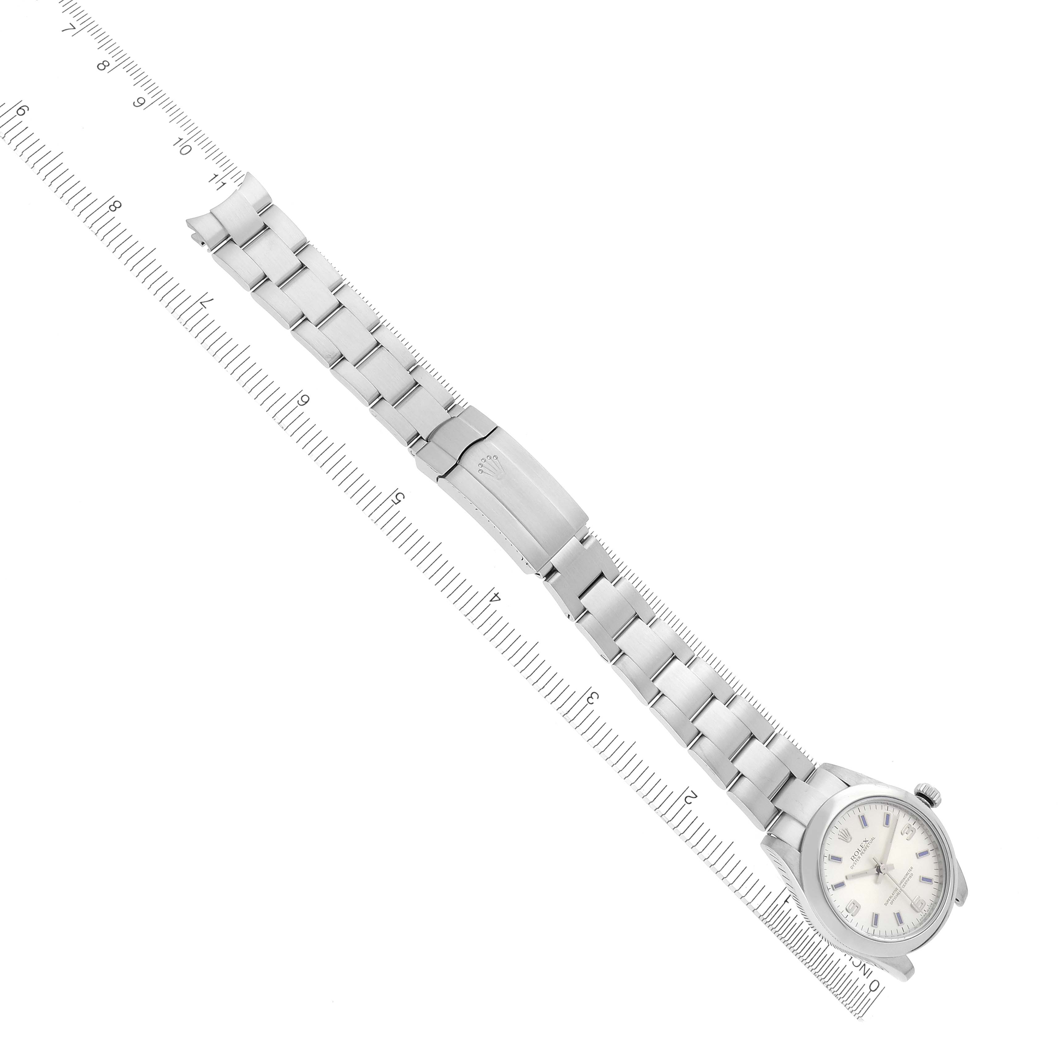 The Rolex Mid-Size 177200 Women's Stainless Steel Silver Dial 177200 Women's Stainless Steel Silver Dial watch is shown from a top-down angle featuring the face, band, and clasp, next to a ruler for scale.