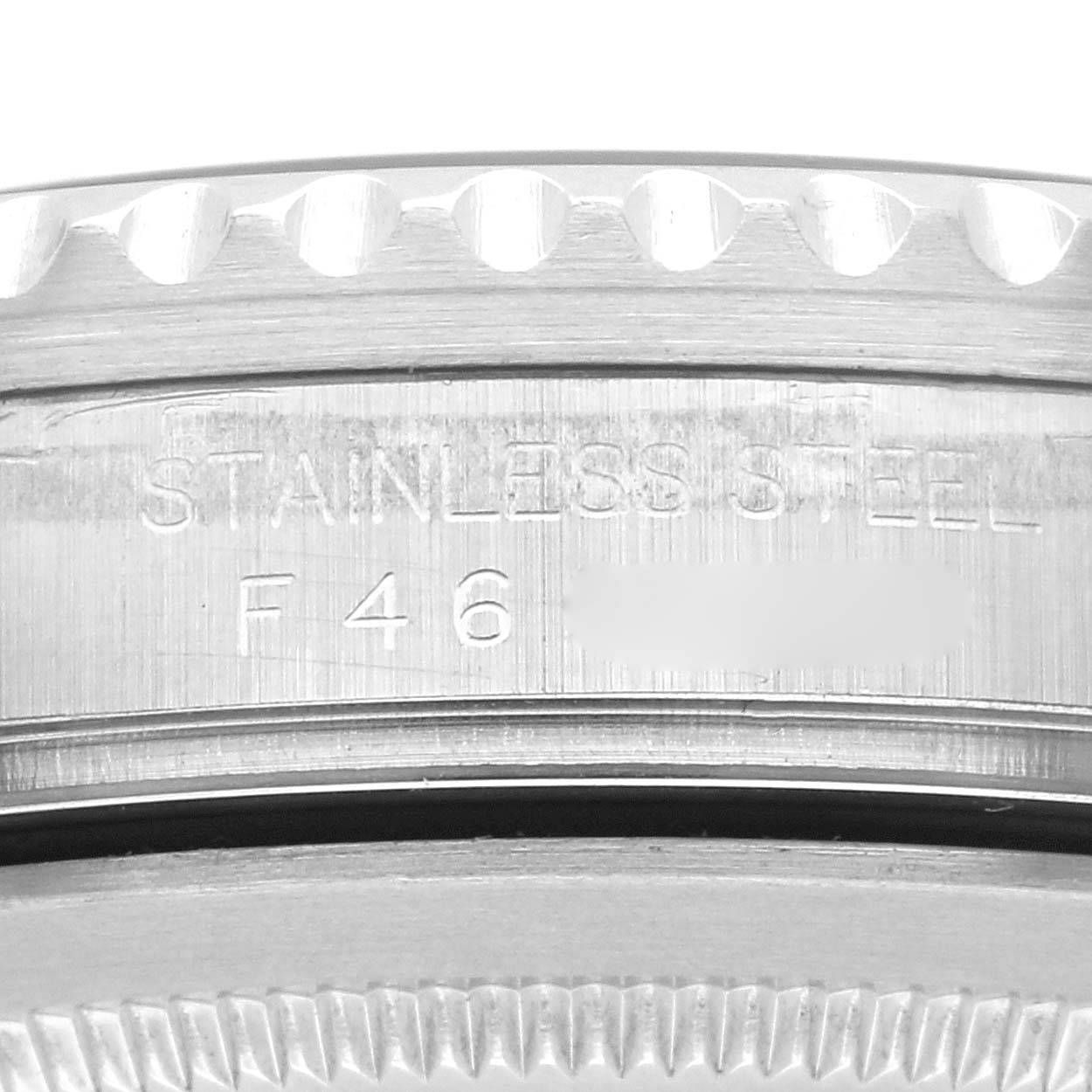 The image shows a close-up of the side engraving on a Rolex GMT-Master 16710 Men's Stainless Steel Black Dial 16710 Men's Stainless Steel Black Dial watch, highlighting its stainless steel material.