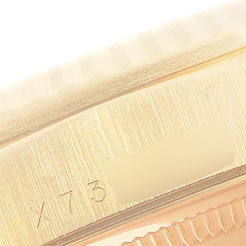 This close-up image shows the fluted bezel and part of the case with an engraving of the Rolex President 18238 Men's Yellow Gold Champagne Dial 18238 Men's Yellow Gold Champagne Dial model.
