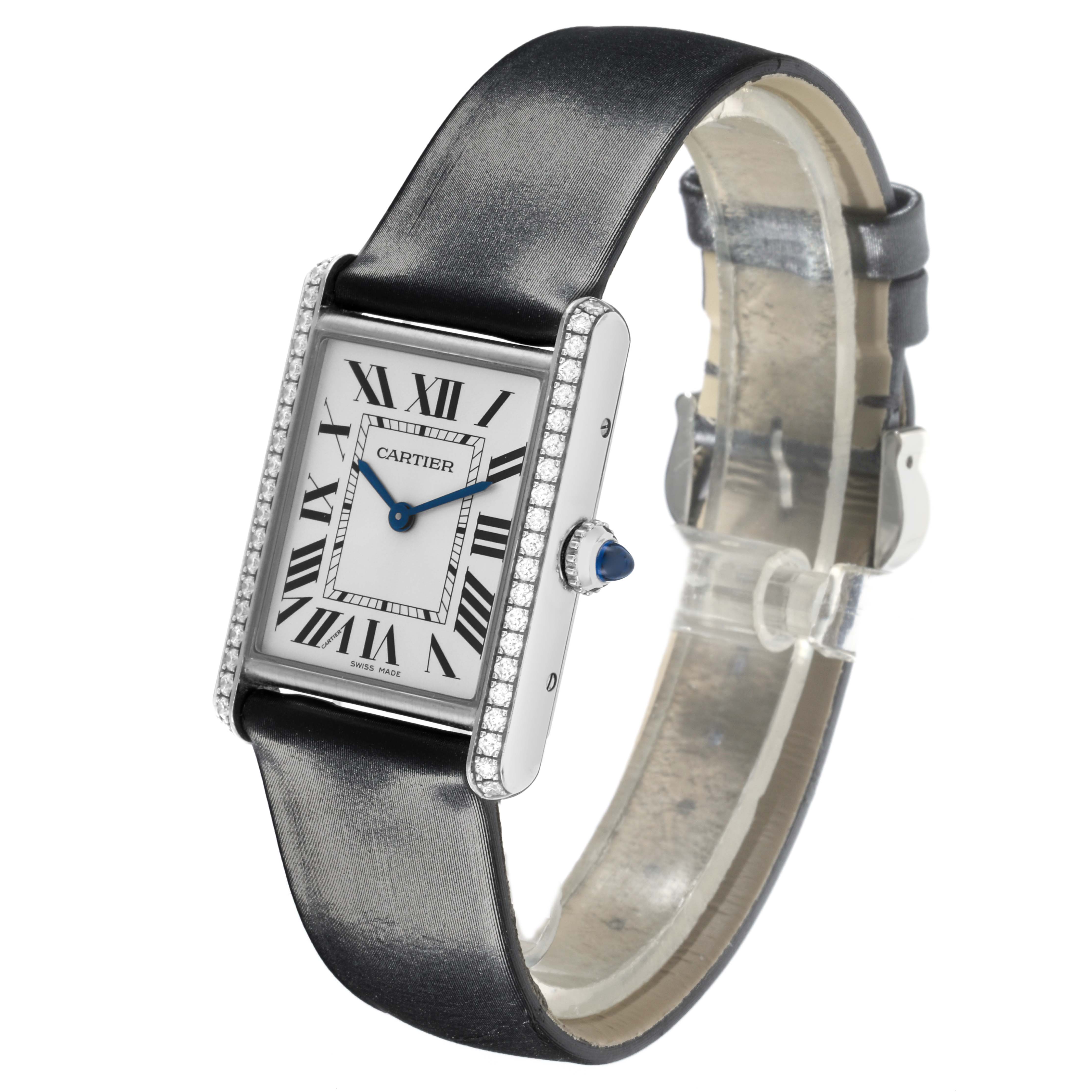 The Cartier Tank Must W4TA0017 Women's Stainless Steel Silver Dial W4TA0017 Women's Stainless Steel Silver Dial watch is shown at an angled side view, highlighting its face, strap, and bejeweled edges.