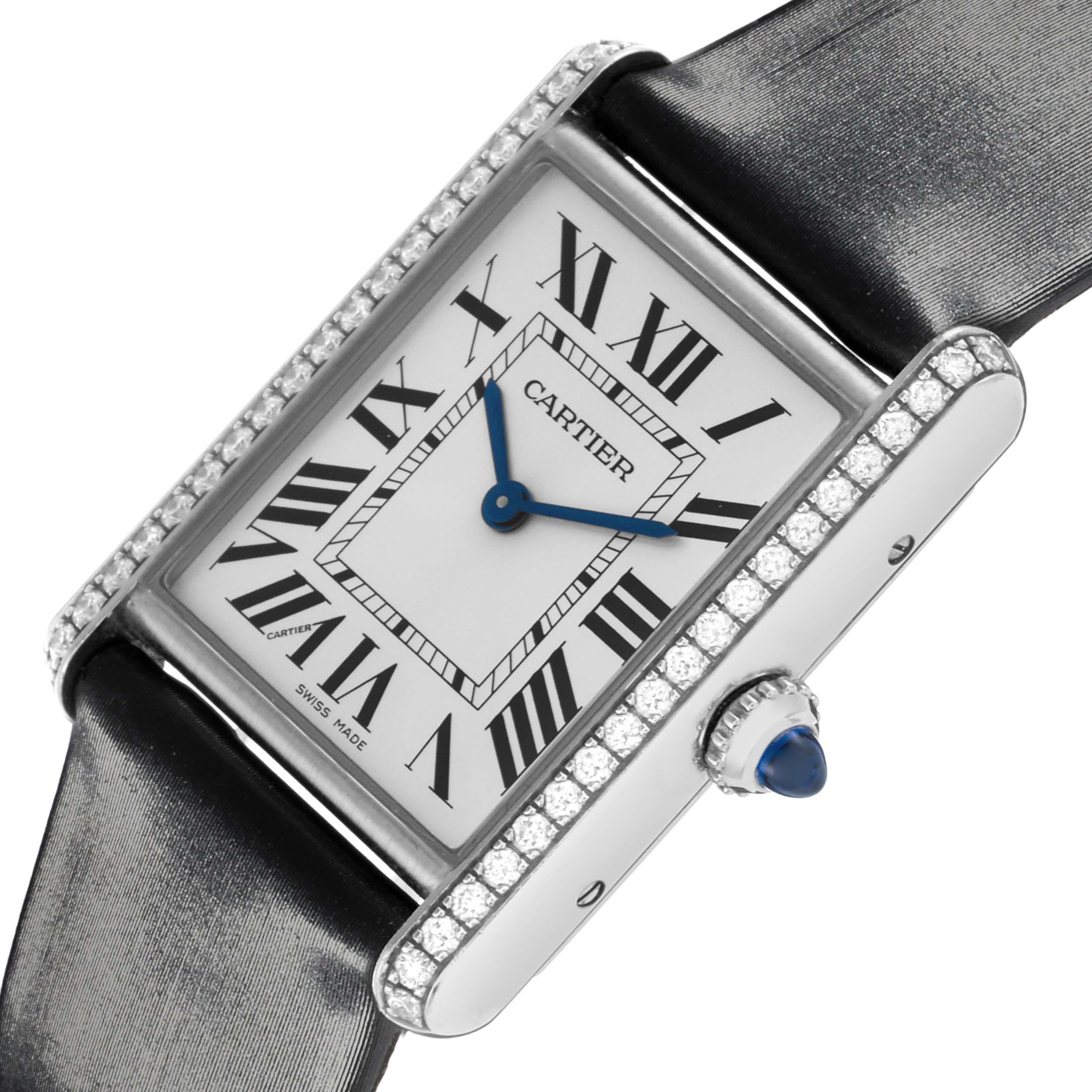 The Cartier Tank Must W4TA0017 Women's Stainless Steel Silver Dial W4TA0017 Women's Stainless Steel Silver Dial watch is shown at an angled close-up, highlighting its rectangular face, Roman numerals, blue hands, and jeweled bezel.