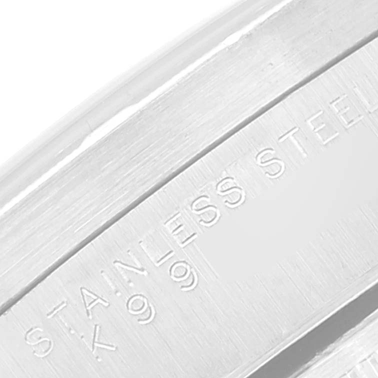 This close-up image shows the "STAINLESS STEEL 990" engraving on the case of a Rolex Date 15210 Men's Stainless Steel Silver Dial 15210 Men's Stainless Steel Silver Dial watch.