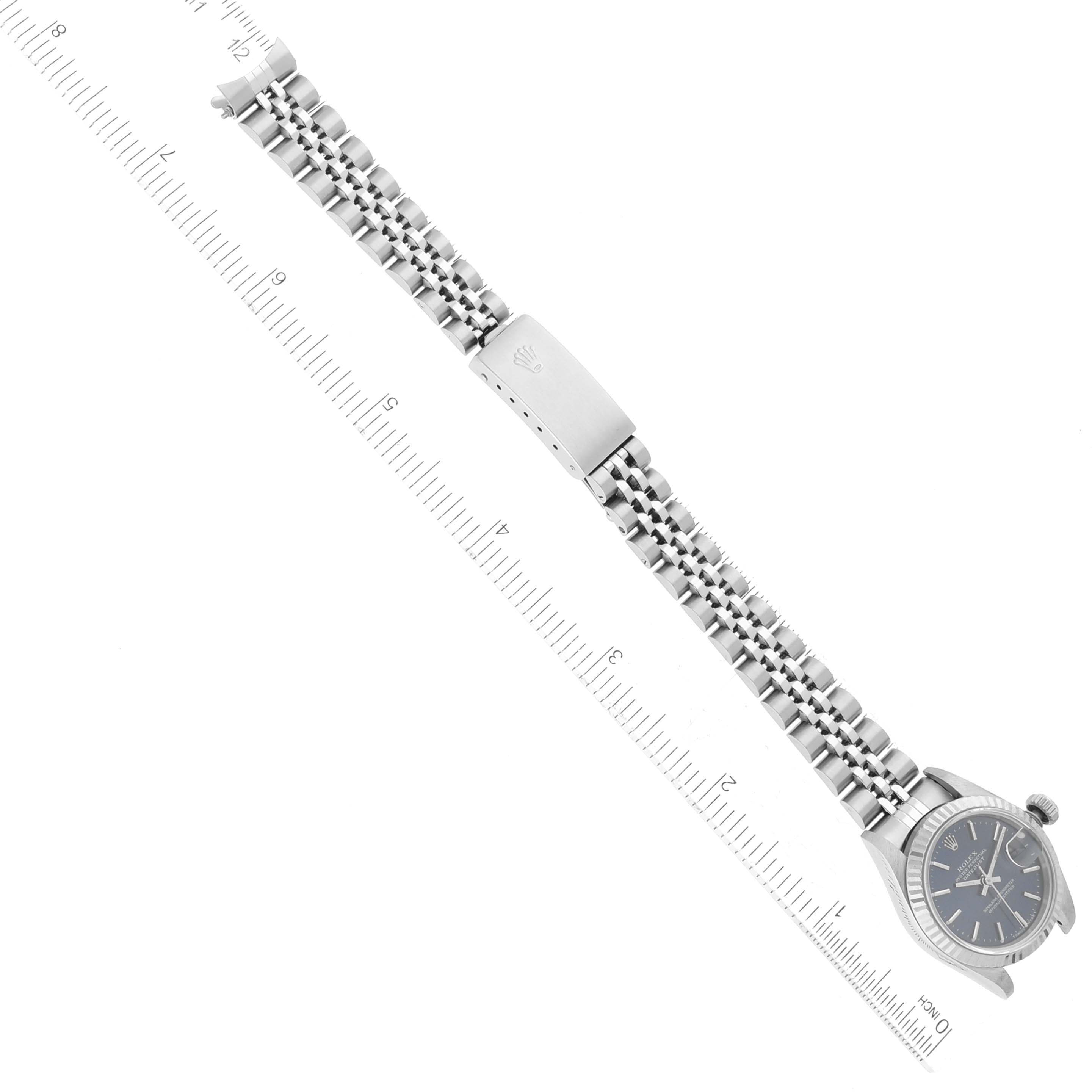 The Rolex Datejust 69174 Women's Stainless Steel Blue Dial 69174 Women's Stainless Steel Blue Dial watch is displayed flat from above, showcasing its full length alongside a ruler for scale.