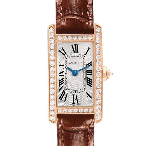 The Cartier Tank Américaine watch is shown from the front, featuring a diamond-set bezel and blue hands.