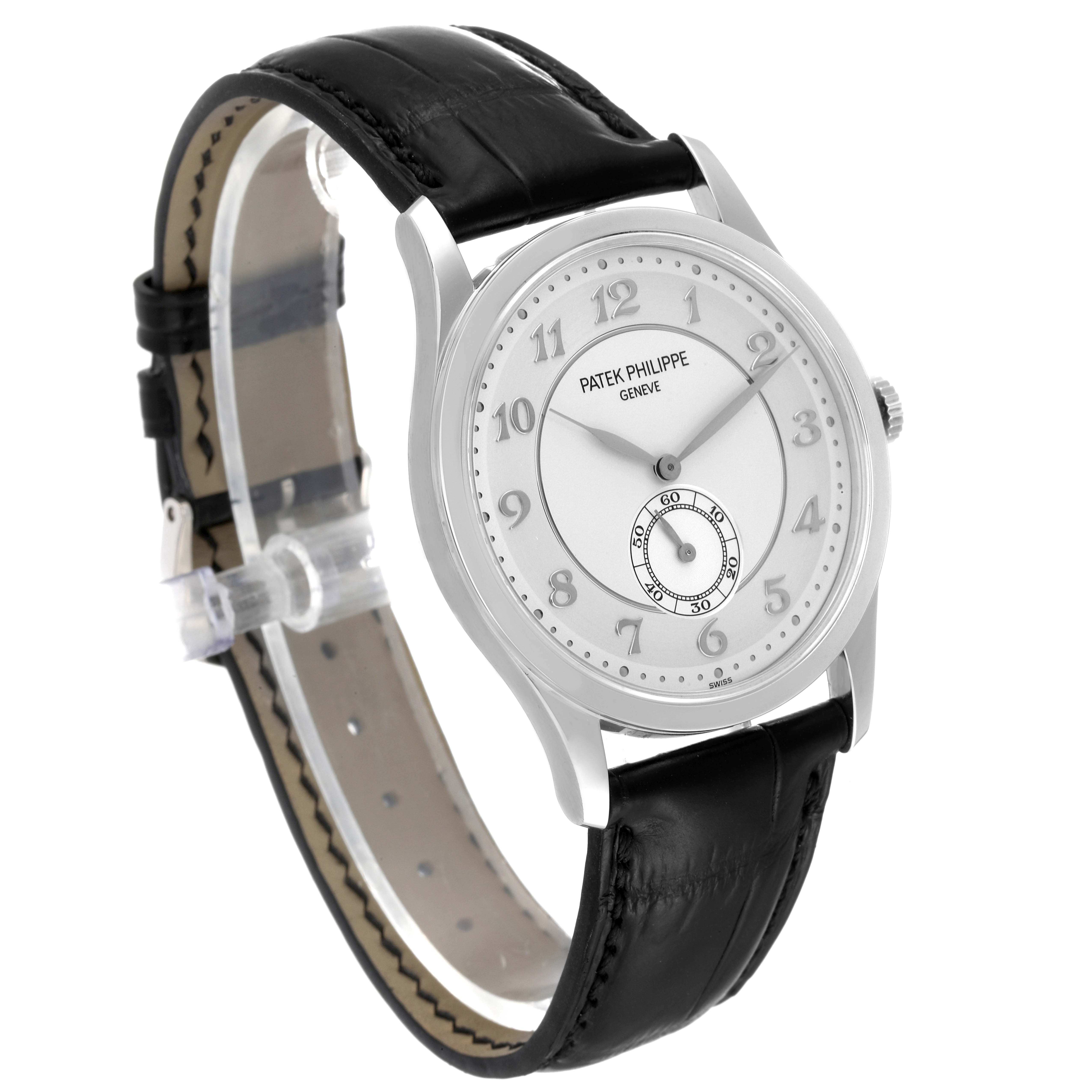 This image shows a Patek Philippe Calatrava 5196P-001 Men's Platinum Silver Dial 5196P-001 Men's Platinum Silver Dial watch viewed from a three-quarter angle, highlighting its face and leather strap.
