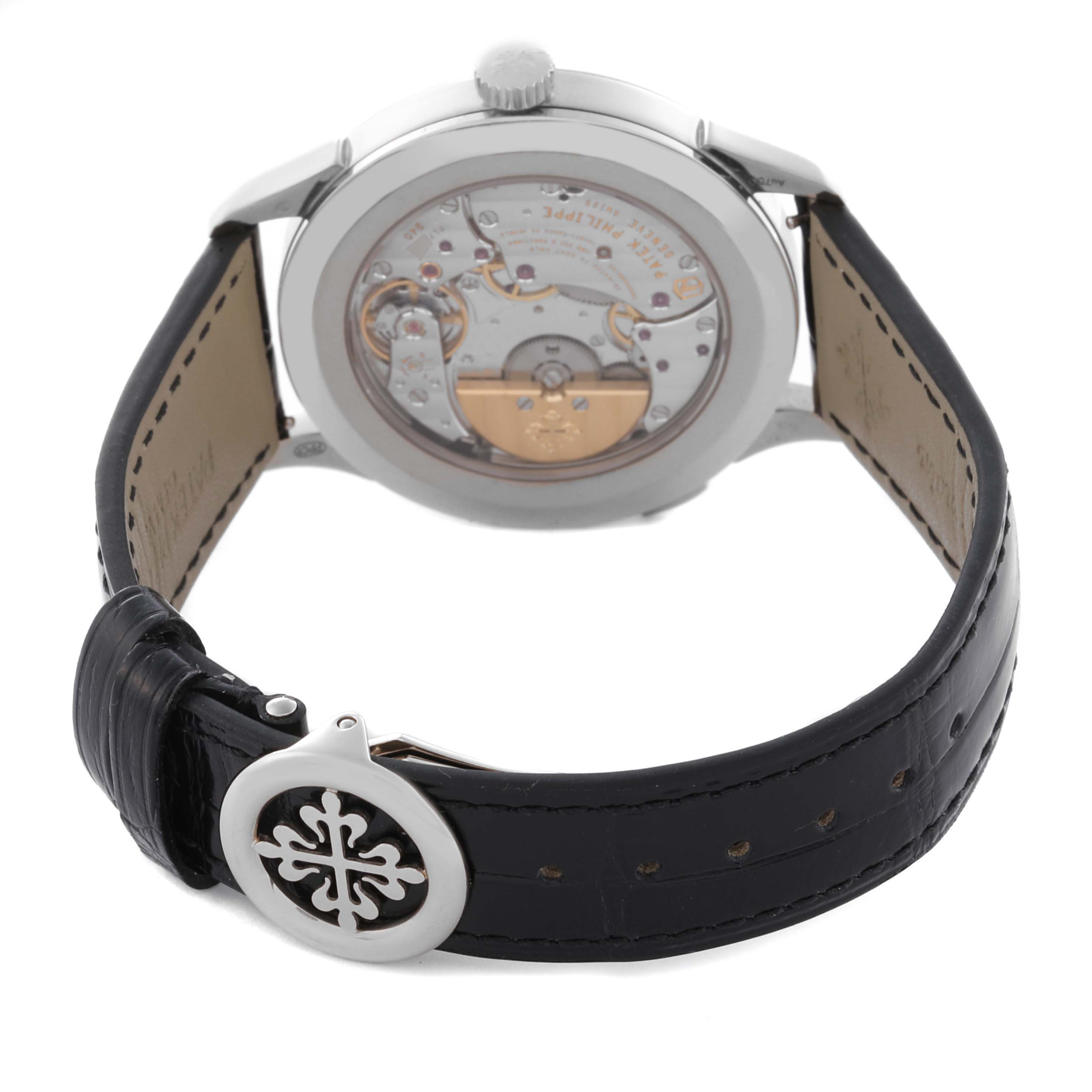 The Patek Philippe Complications 5230G-001 Men's White Gold Grey Dial 5230G-001 Men's White Gold Grey Dial watch is shown from the back, highlighting the movement and leather strap with clasp.