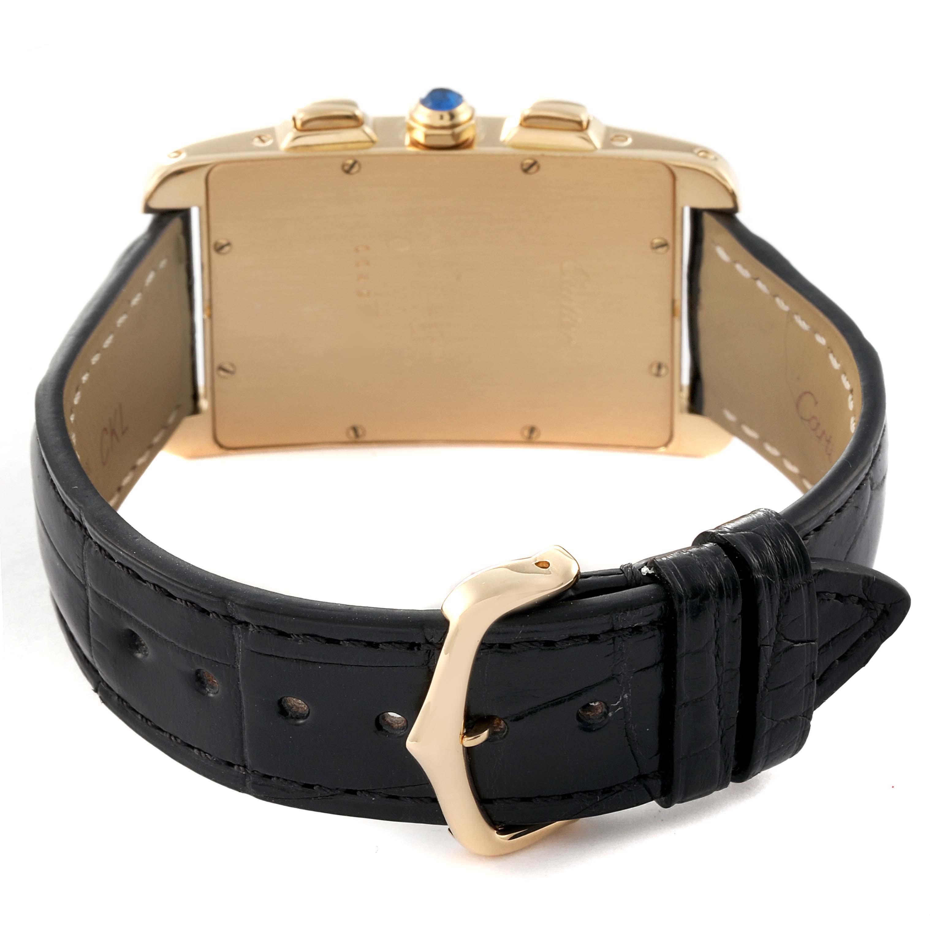 This image shows the back view of the Cartier Tank Americaine W2601156 Men's Yellow Gold Silver Dial W2601156 Men's Yellow Gold Silver Dial watch, highlighting its case, crown, and leather strap with a buckle.