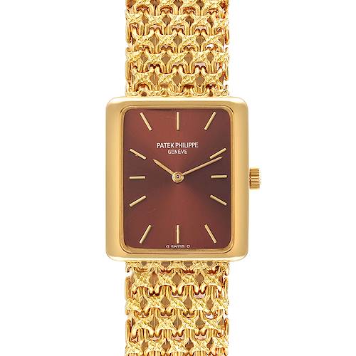 The image shows a frontal view of a Patek Philippe Gondolo 4224 - 1 Women's Yellow Gold Brown Dial 4224 - 1 Women's Yellow Gold Brown Dial watch, displaying its rectangular dial and detailed gold bracelet.