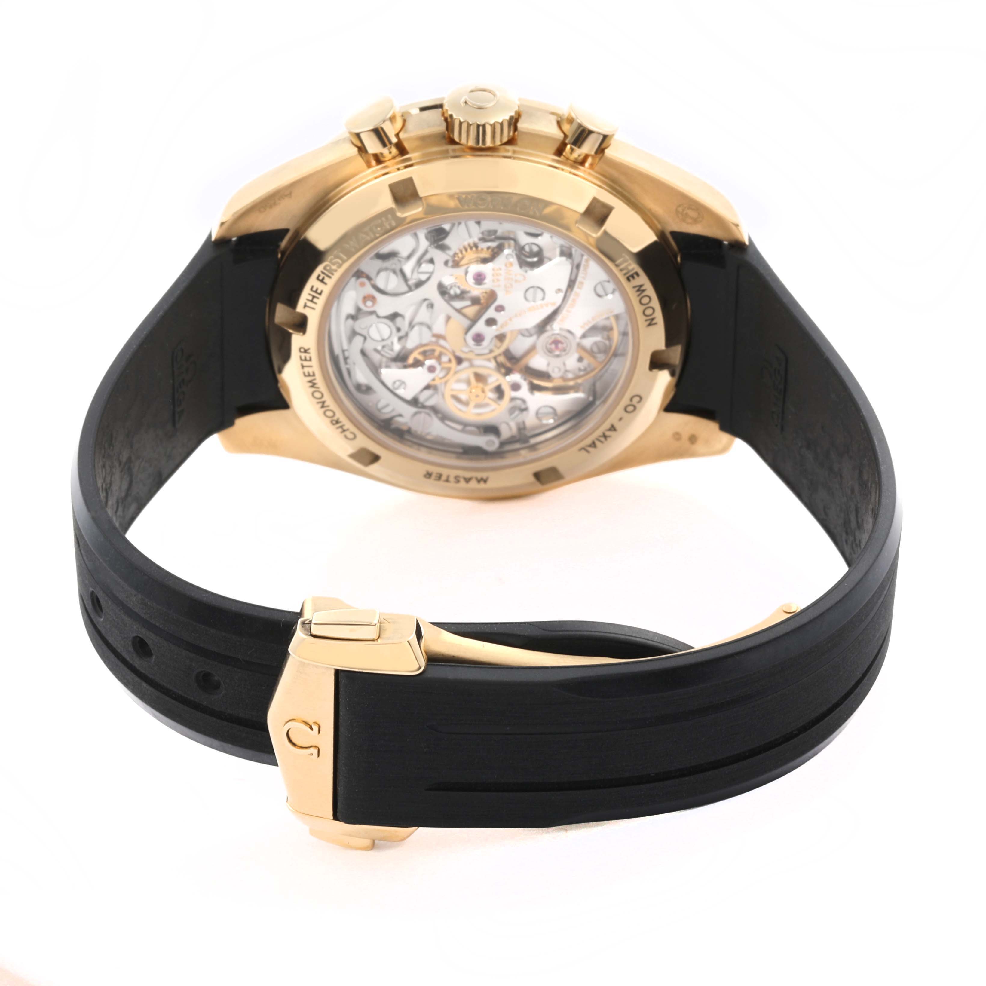 The Omega Speedmaster 310.62.42.50.99.001 Men's Yellow Gold Champagne Dial 310.62.42.50.99.001 Men's Yellow Gold Champagne Dial watch is shown from the back, highlighting its transparent case back and black strap.