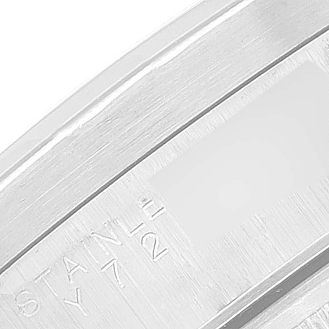This image shows a close-up of the clasp from a Rolex Date 15210 Men's Stainless Steel Black Dial 15210 Men's Stainless Steel Black Dial model watch, highlighting the engraving on the stainless steel surface.