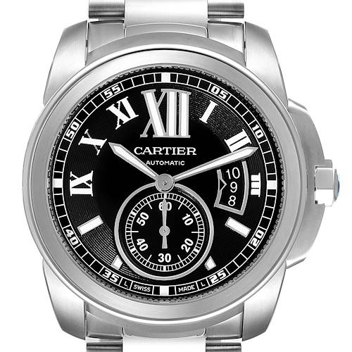 The image shows a frontal view of the Calibre de Cartier watch by Cartier, highlighting its black dial, Roman numerals, and steel bracelet.