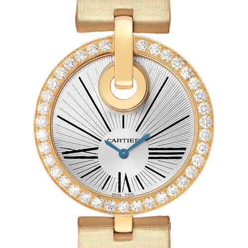 The image shows a close-up of the Cartier Ballon Bleu WG600010 Women's Yellow Gold Silver Dial watch face, highlighting its diamond-studded gold bezel and elegant hands.