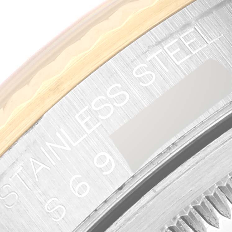 This is a close-up of the stainless steel and gold bezel of a Rolex Datejust 16233 Men's Steel and Gold (two tone) Champagne Dial 16233 Men's Steel and Gold (two tone) Champagne Dial watch, showing part of the case and engraving.