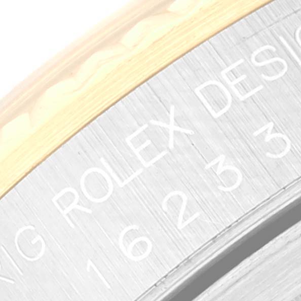 Close-up of the Rolex Datejust 16233 Men's Steel and Gold (two tone) Champagne Dial 16233 Men's Steel and Gold (two tone) Champagne Dial case edge showing the model number engraving and part of the bezel.