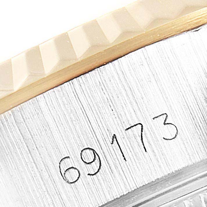 This image shows a close-up of the edge and part of the serial number of a Rolex Datejust 69173 Women's Steel and Gold (two tone) Silver Dial 69173 Women's Steel and Gold (two tone) Silver Dial model watch.